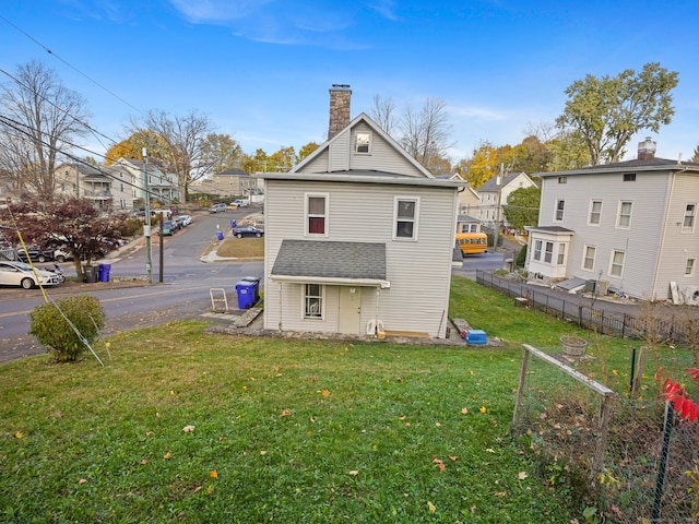 rear view of house with a yard