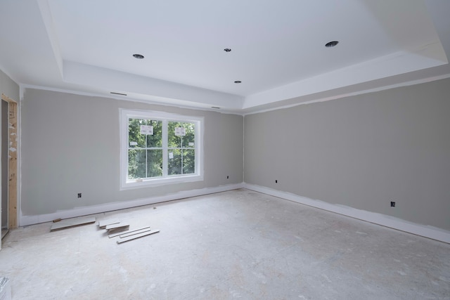 unfurnished room with a tray ceiling