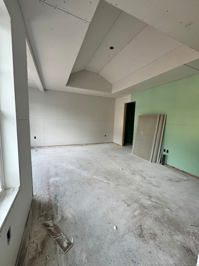 empty room with lofted ceiling