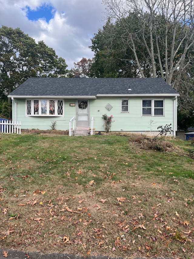 single story home featuring a front lawn