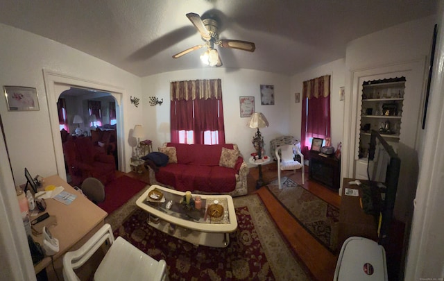 living room featuring ceiling fan and vaulted ceiling