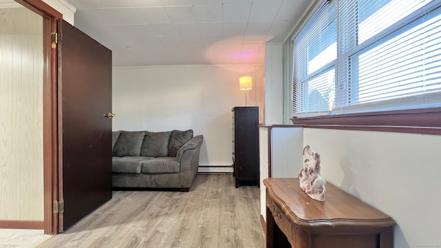 sitting room featuring light hardwood / wood-style floors and baseboard heating