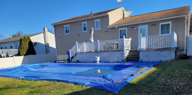 rear view of house with a pool side deck