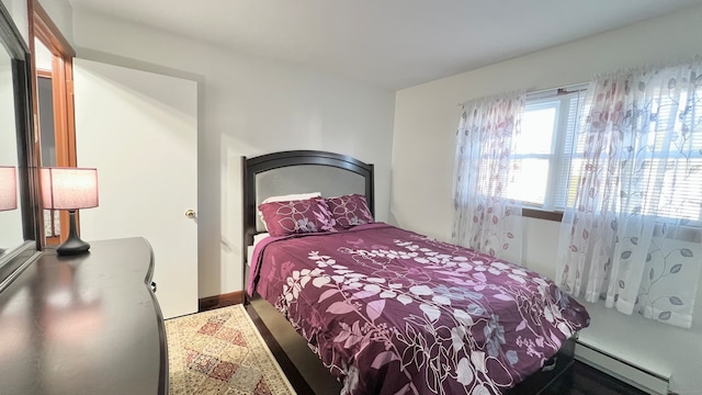 bedroom with a baseboard heating unit