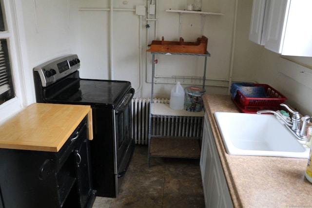 laundry area with radiator heating unit and sink