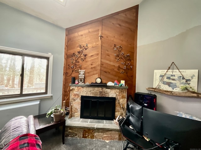 living area featuring a stone fireplace