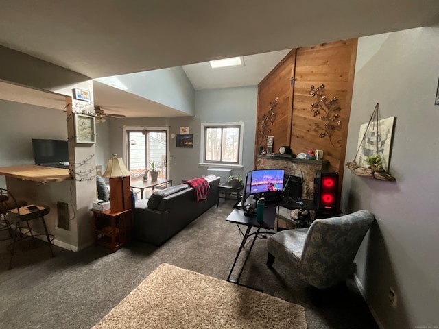 carpeted living room with ceiling fan and vaulted ceiling