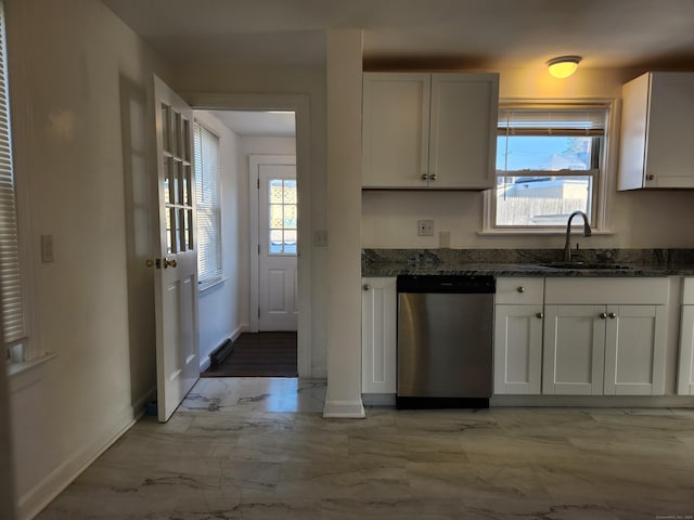 kitchen with dishwasher, white cabinetry, and dark stone countertops