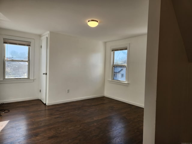 unfurnished room featuring dark hardwood / wood-style flooring