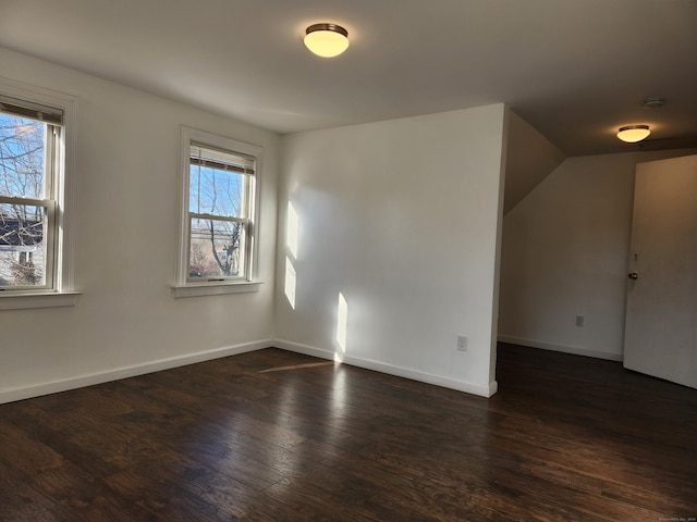 bonus room featuring a wealth of natural light and dark wood-type flooring