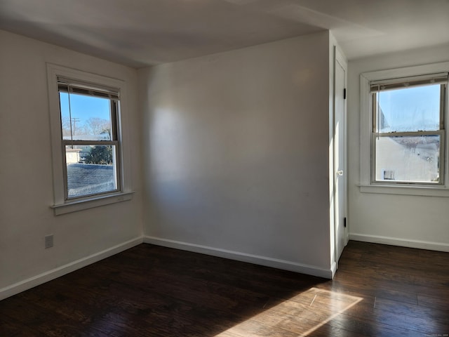 spare room with dark hardwood / wood-style floors