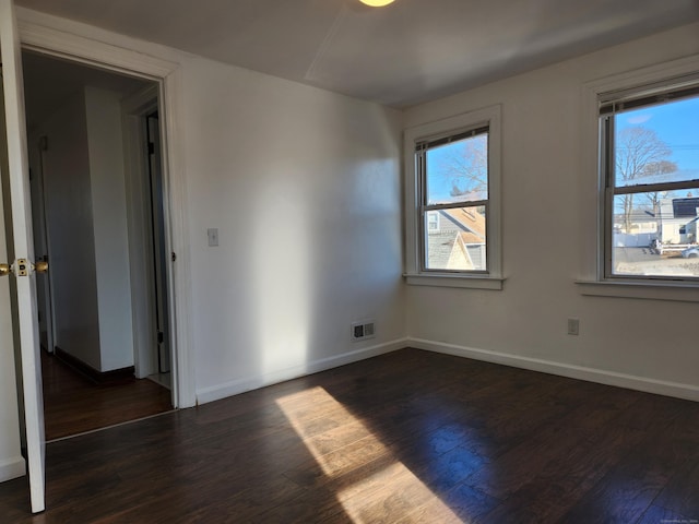 empty room featuring dark hardwood / wood-style flooring