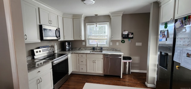 kitchen with sink, stainless steel appliances, dark hardwood / wood-style floors, pendant lighting, and white cabinets