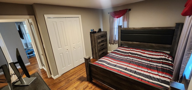 bedroom with hardwood / wood-style flooring and a closet