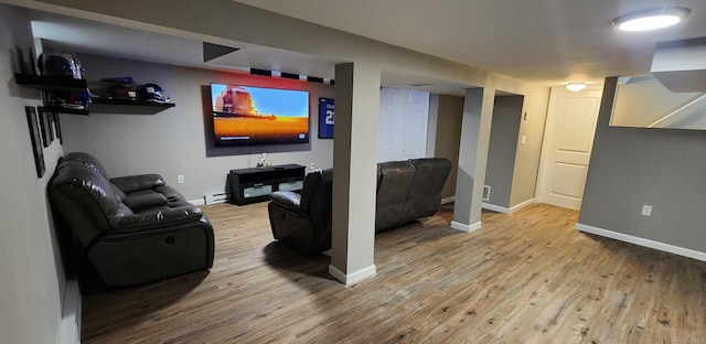 living room with light hardwood / wood-style floors and baseboard heating