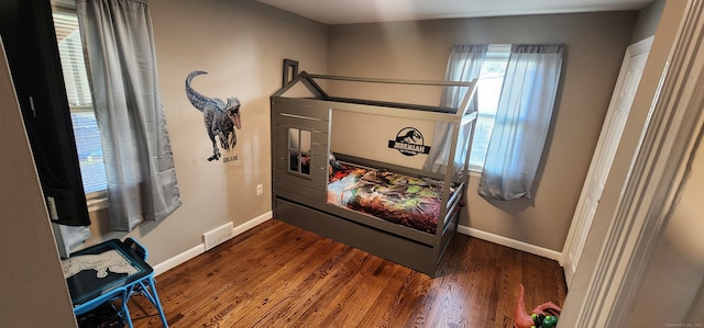 bedroom with dark hardwood / wood-style floors