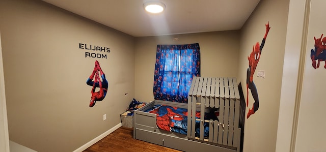 bedroom with dark wood-type flooring