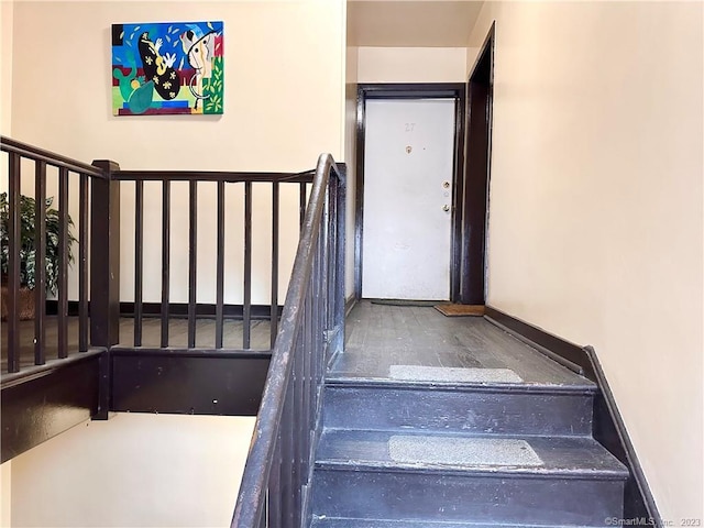 staircase with hardwood / wood-style flooring