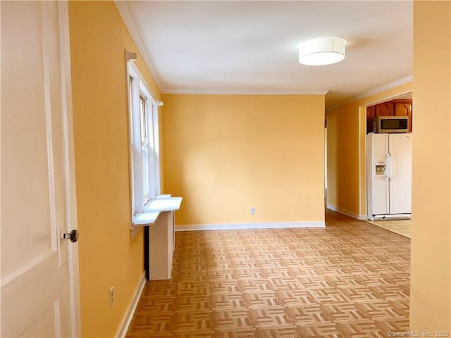 spare room featuring light parquet flooring and ornamental molding