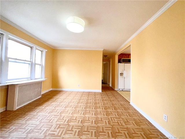 unfurnished room with ornamental molding and light parquet floors