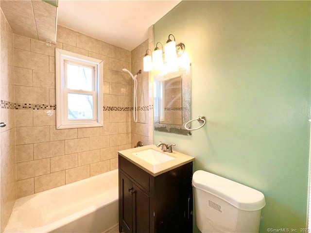 full bathroom with vanity, toilet, and tiled shower / bath