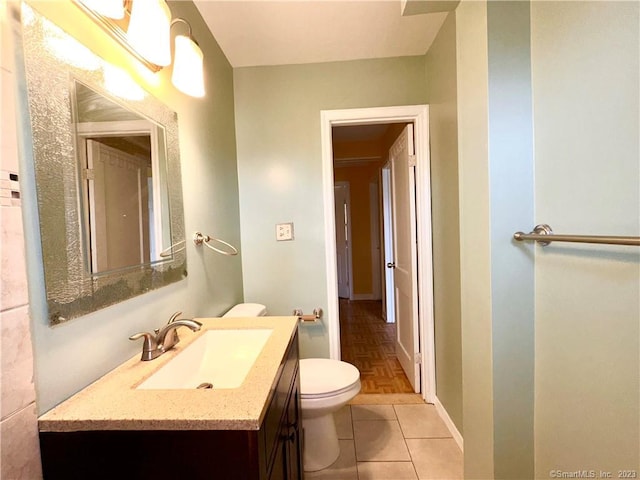 bathroom featuring tile patterned floors, vanity, and toilet