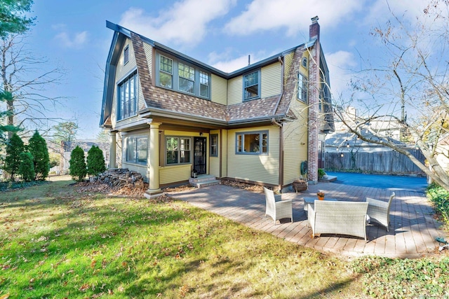 rear view of property featuring a yard