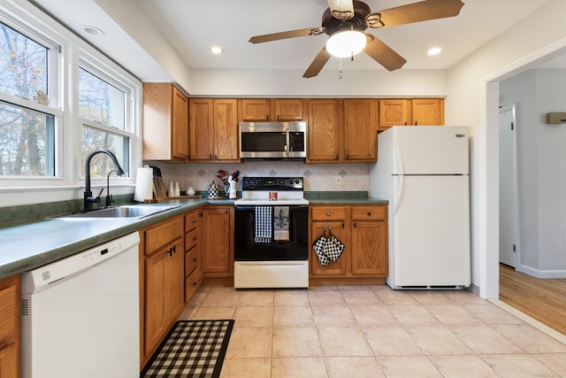 kitchen featuring sink, white appliances, ceiling fan, tasteful backsplash, and light tile patterned flooring