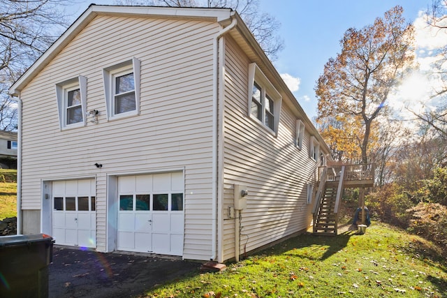 view of property exterior with a garage and a deck