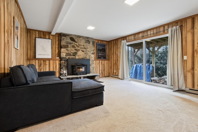 living room with a baseboard heating unit, light carpet, beam ceiling, and wood walls