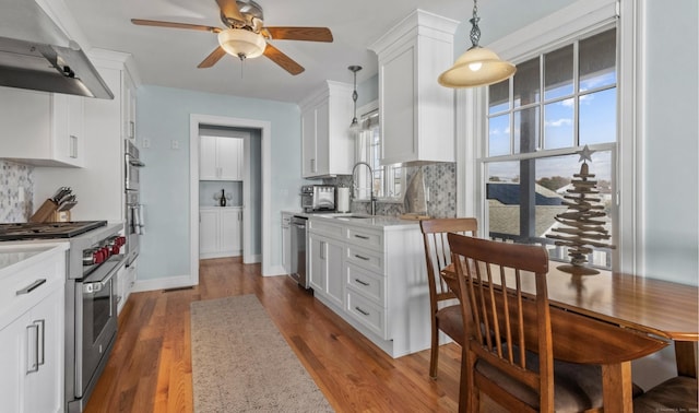 442 Seaside Ave, Westbrook, CT 06498 - kitchen with stainless steel appliances, under cabinet range hood, a sink, and light countertops