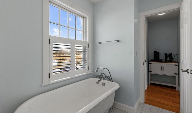 bathroom featuring a washtub and hardwood / wood-style flooring