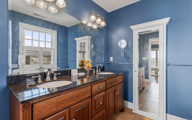 442 Seaside Ave, Westbrook, CT 06498 - full bath featuring tile patterned floors, healthy amount of natural light, double vanity, and baseboards