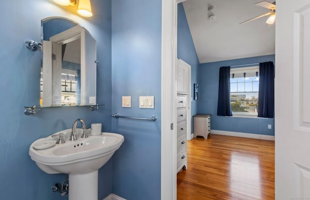 bathroom featuring wood-type flooring, vaulted ceiling, and ceiling fan