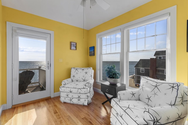 442 Seaside Ave, Westbrook, CT 06498 - sitting room featuring a water view, wood finished floors, a ceiling fan, and baseboards