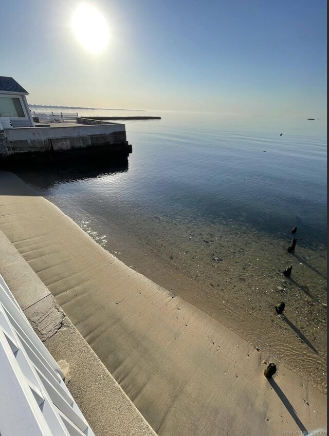 view of dock with a view of the beach and a water view