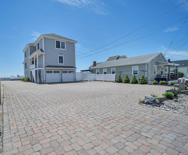 442 Seaside Ave, Westbrook, CT 06498 - back of house featuring a garage, driveway, fence, and stairs