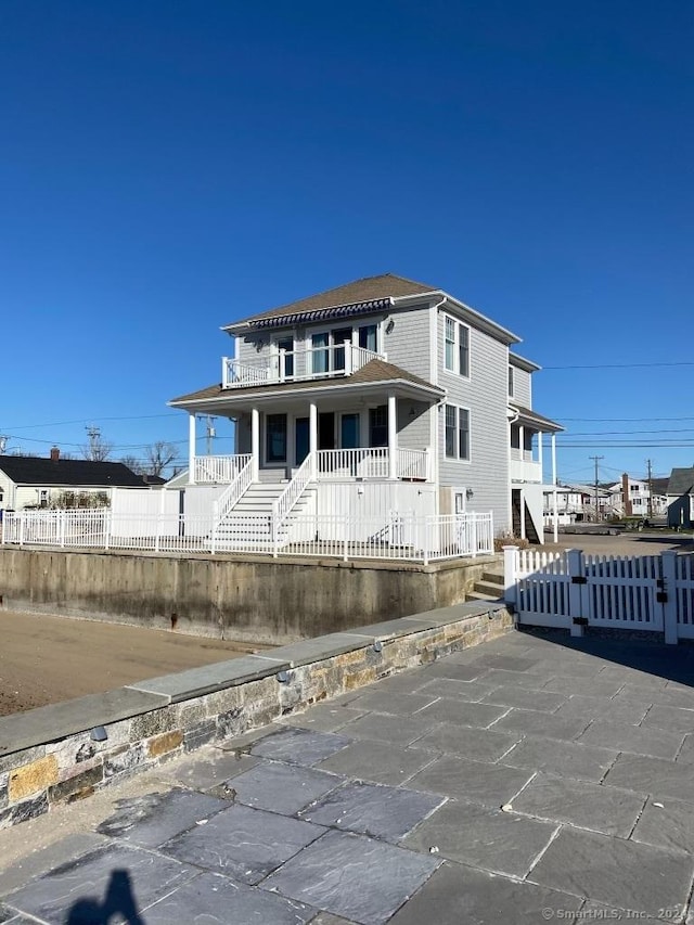 442 Seaside Ave, Westbrook, CT 06498 - view of front of home with fence, stairway, and covered porch