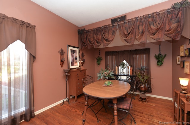 dining space with hardwood / wood-style floors