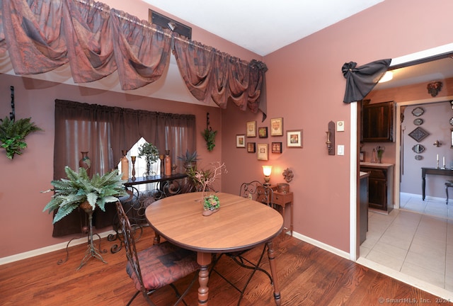 dining space with hardwood / wood-style flooring