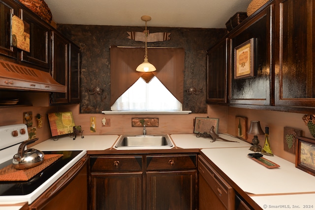 kitchen featuring sink, exhaust hood, electric range, dark brown cabinets, and decorative light fixtures