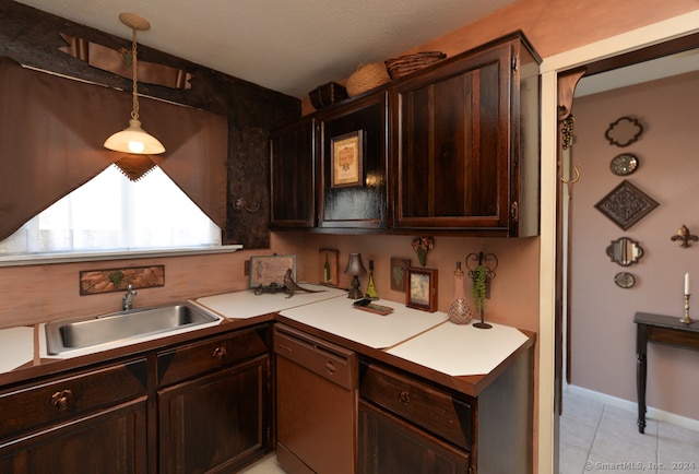 kitchen featuring sink, light tile patterned floors, dishwashing machine, dark brown cabinets, and pendant lighting