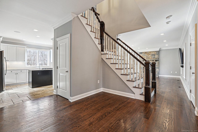 entrance foyer with crown molding and hardwood / wood-style floors