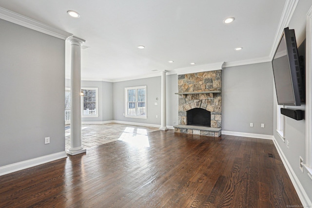 unfurnished living room featuring ornate columns, ornamental molding, a fireplace, and wood-type flooring