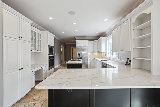 kitchen with kitchen peninsula, white cabinetry, stainless steel appliances, and tasteful backsplash