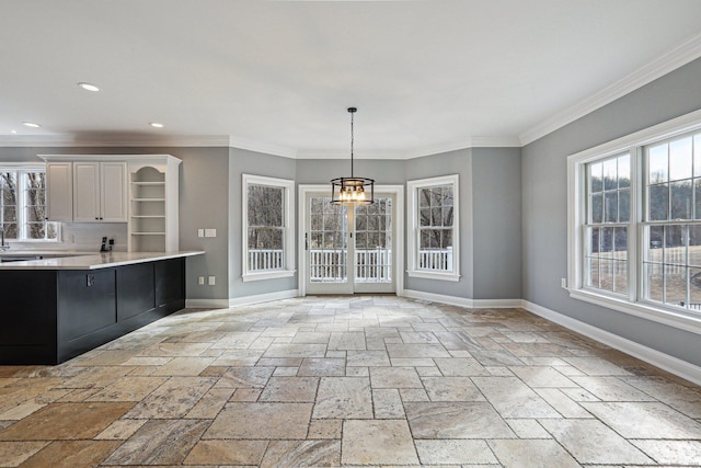 kitchen featuring decorative light fixtures, a notable chandelier, a wealth of natural light, and white cabinetry