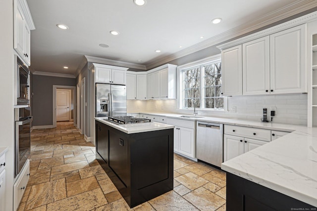 kitchen with decorative backsplash, white cabinetry, stainless steel appliances, and a kitchen island