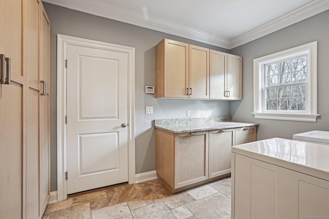 kitchen featuring separate washer and dryer, ornamental molding, and light brown cabinets