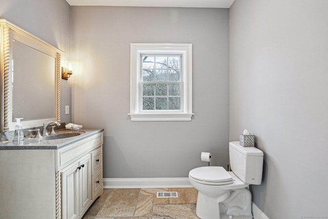 bathroom with toilet and vanity