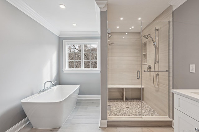 bathroom with crown molding, shower with separate bathtub, hardwood / wood-style flooring, and vanity